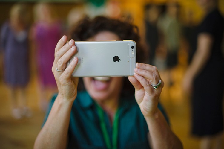 Woman taking photo with her mobile phone